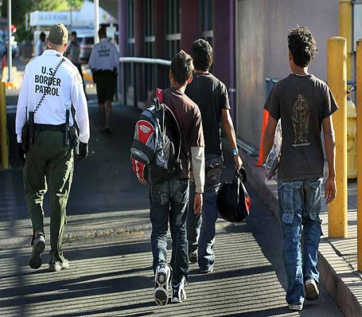 NOGALES, AZ - JUNE 02: An U.S. Customs and Border Protection agent escorts Mexican's being returned to Mexico after they were apprehended for entering the United States illegally June 2, 2010 in Nogales, Arizona. During the 2009 fiscal year 540,865 undocumented immigrants were apprehended entering the United States illegally along the Mexican border, 241,000 of those were captured in the 262 mile stretch of the border known as the Tucson Sector. (Photo by Scott Olson/Getty Images)