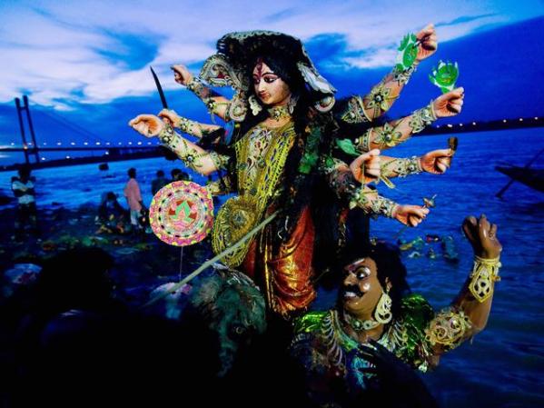 Fieles hinduistas sumergen una imagen de su deidad Durga en el río Ganges durante la celebración del festival Durga Puja.