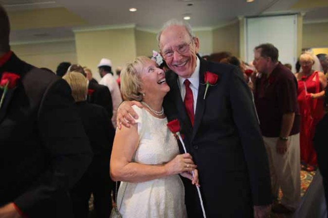 WEST PALM BEACH, FL - FEBRUARY 14: Arlene Joseph and Stuart Joseph (L-R) smile after being wed during a group Valentine's day wedding at the National Croquet Center on February 14, 2013 in West Palm Beach, Florida. The group wedding ceremony is put on by the Palm Beach Country Clerk & Comptroller's office and approximately 40 couples to tied the knot. (Photo by Joe Raedle/Getty Images)