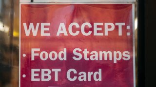A poster stating they accept the food stamps and EBT card.
