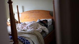 BROOKLYN, NY - NOVEMBER 21: A COVID-19 patient, exhausted by the virus, spends a morning in bed while trying to recover at home, November 21, 2020, in Brooklyn, New York. As the holidays approach, millions of Americans are recovering from the virus at home