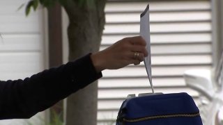 Person submitting mail-in ballot