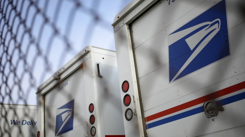 United States Postal Service (USPS) mail delivery vehicles outside a post office in Cincinnati, Ohio, US, on Saturday, July 2, 2022. Beginning July 10, the cost of postage stamps will increase from 58 cents to 60 cents, and the cost to mail one metered mail piece will increase from 53 cents to 57 cents. Photographer: Luke Sharrett/Bloomberg via Getty Images