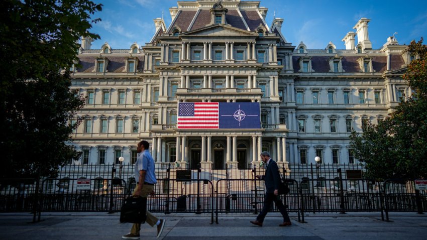 09 July 2024, USA, Washington: Passers-by walk past the Eisenhower Building with the US and NATO flags in the early morning. The NATO summit begins with celebrations to mark the 75th anniversary of the defense alliance. Photo: Kay Nietfeld/dpa (Photo by Kay Nietfeld/picture alliance via Getty Images)