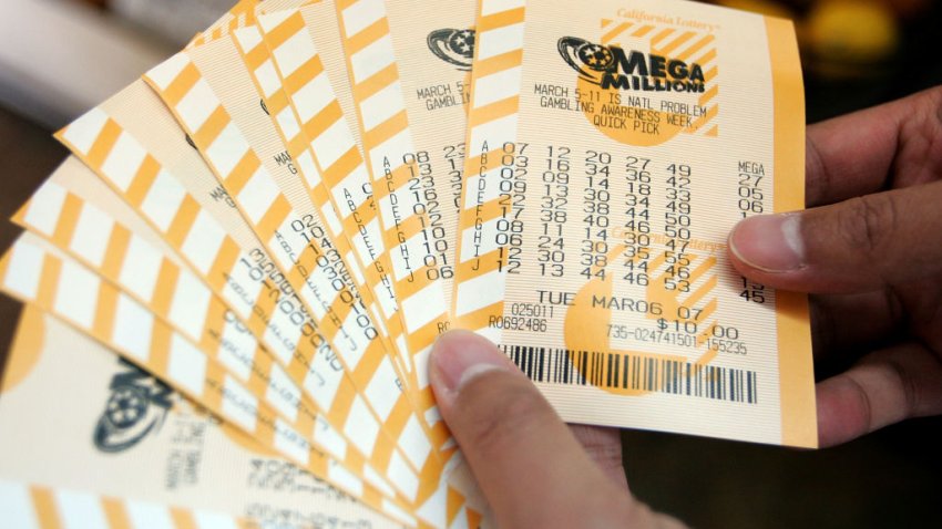 SAN FRANCISCO – MARCH 06:   A man holds a bundle of Mega Millions lottery tickets that he just purchased March 6, 2007 in San Francisco, California. The lottery jackpot was up to $370 million for tonight’s drawing, which will take place in New York’s Times Square instead of the usual drawing location in Atlanta.  (Photo by Justin Sullivan/Getty Images)