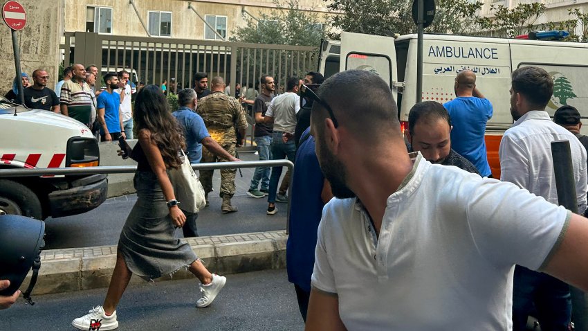 People react near an ambulance as the wounded are brought to a hospital in Beirut on September 17, 2024, after explosions hit locations in several Hezbollah strongholds around Lebanon amid ongoing cross-border tensions between Israel and Hezbollah fighters. Hundreds of people were wounded when Hezbollah members’ paging devices exploded simultaneously across Lebanon on September 17, in what a source close to the militant movement said was an “Israeli breach” of its communications. (Photo by Anwar AMRO / AFP) (Photo by ANWAR AMRO/AFP via Getty Images)