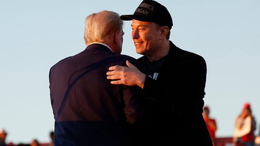 Elon Musk embraces Republican presidential nominee, former President Donald Trump during a campaign rally at the Butler Farm Show fairgrounds on October 05, 2024 in Butler, Pennsylvania. This is the first time that Trump has returned to Butler since he was injured during an attempted assassination on July 13.