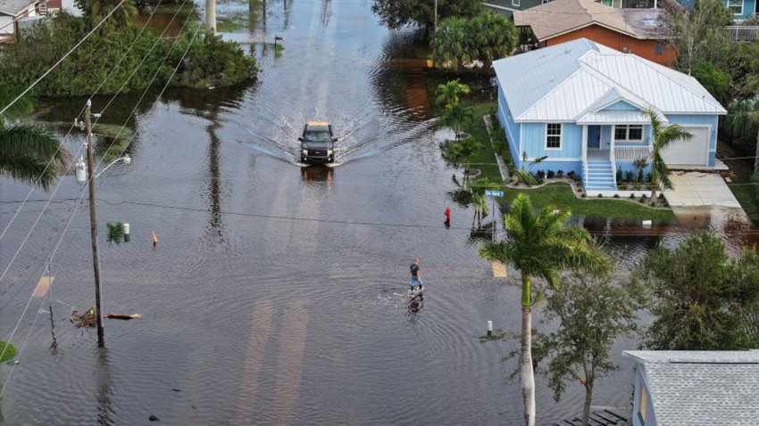 PUNTA GORDA – OCTOBER 10: In this aerial view, a person walks through flood waters that inundated a neighborhood after Hurricane Milton came ashore on October 10, 2024, in Punta Gorda, Florida. The storm made landfall as a Category 3 hurricane in the Siesta Key area of Florida, causing damage and flooding throughout Central Florida. (Photo by Joe Raedle/Getty Images)