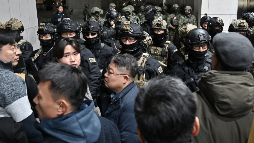 Soldiers try to enter the National Assembly building in Seoul on December 4 2024, after South Korea President Yoon Suk Yeol declared martial law. South Korea’s President Yoon Suk Yeol on December 3 declared martial law, accusing the opposition of being “anti-state forces” and saying he was acting to protect the country from “threats” posed by the North. (Photo by Jung Yeon-je / AFP) (Photo by JUNG YEON-JE/AFP via Getty Images)