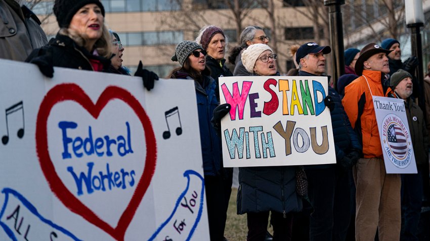 Demonstrators hold signs in support of federal workers outside of the L’Enfant metro station in Washington, DC, US, on Monday, Feb. 24, 2025. Elon Musk’s demand that more than two million federal employees defend their work is facing pushback from other powerful figures in the Trump administration, in a sign that the billionaire’s brash approach to overhauling the government is creating division. Photographer: Al Drago/Bloomberg via Getty Images