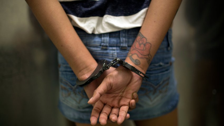 LOS ANGELES, CA – FEBRUARY 2: A 17-year old girl in hand-cuffs is questioned February 2, 2013 by a vice squad policeman with the Los Angeles Police Department’s South Central’s 77th Street Division about committing prostitution in Los Angeles, California. While the charge of soliciting or loitering with the intent to commit prostitution is a misdemeanor, the girl will be held for 2-4 days. As a minor, the girl was formally charged with prostitution. The majority of juveniles arrested for prostitution in Los Angeles county come from the city’s foster care program. In 2010, police in Los Angeles arrested 174 juveniles for prostitution. In South Central Los Angeles, prostitution flourishes and is often controlled by pimps who are former Bloods or Crips gang members. (Photo by Robert Nickelsberg/Getty Images)