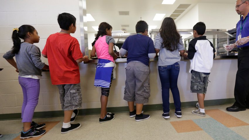 ARCHIVO – Menores inmigrantes detenidos forman una fila en la cafetería del Centro Residencial del Condado de Karnes, un centro de detención para familias inmigrantes, en la ciudad de Karnes, Texas, el 10 de septiembre de 2014. (AP Foto/Eric Gay, Archivo)