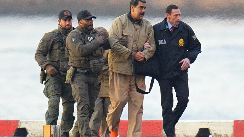 Nicolas Maduro and his wife, Cilia Flores, are seen in handcuffs after landing at a Manhattan helipad, escorted by heavily armed Federal agents as they make their way into an armored car en route to a Federal courthouse in Manhattan on January 5, 2026 in New York City.  (Photo by XNY/Star Max/GC Images)