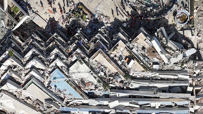 TOPSHOT – This aerial view shows a collapsed multi-storey building and surrounding debris near a coastal road following the June 24 twin earthquakes in Caraballeda, La Guaira State, Venezuela, on June 29, 2026. Hopes were fading of finding survivors more than four days after powerful twin earthquakes struck Venezuela, as residents grow increasingly frustrated with the government’s response to the disaster that has killed -up to now- more than 1,700 people and left tens of thousands unaccounted for. (Photo by Yorman MALDONADO / AFP via Getty Images)